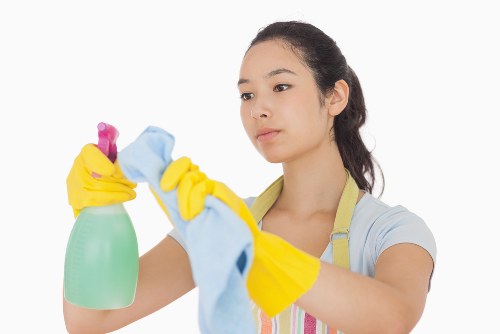Kitchen surfaces being cleaned during house cleaning in W11